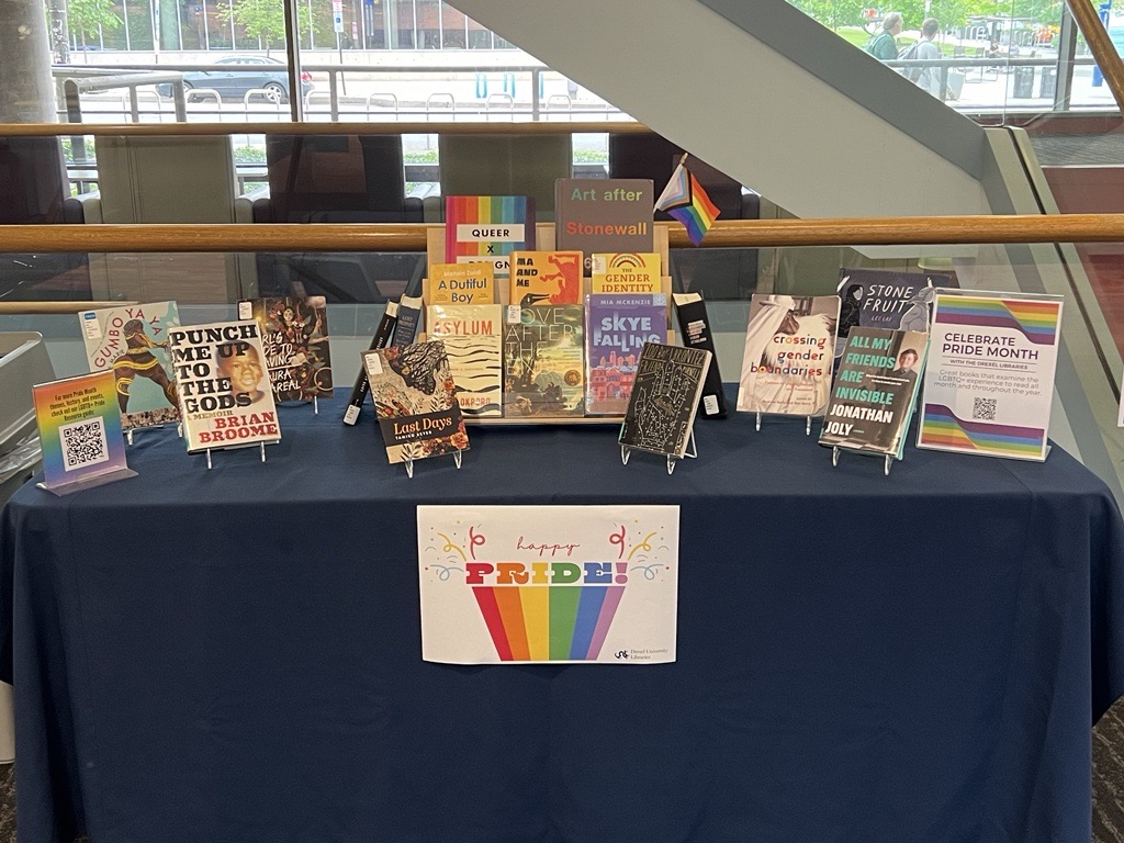 A photo of the 2024 Pride Month book display in Hagerty Library, featuring 19 books and several signs.